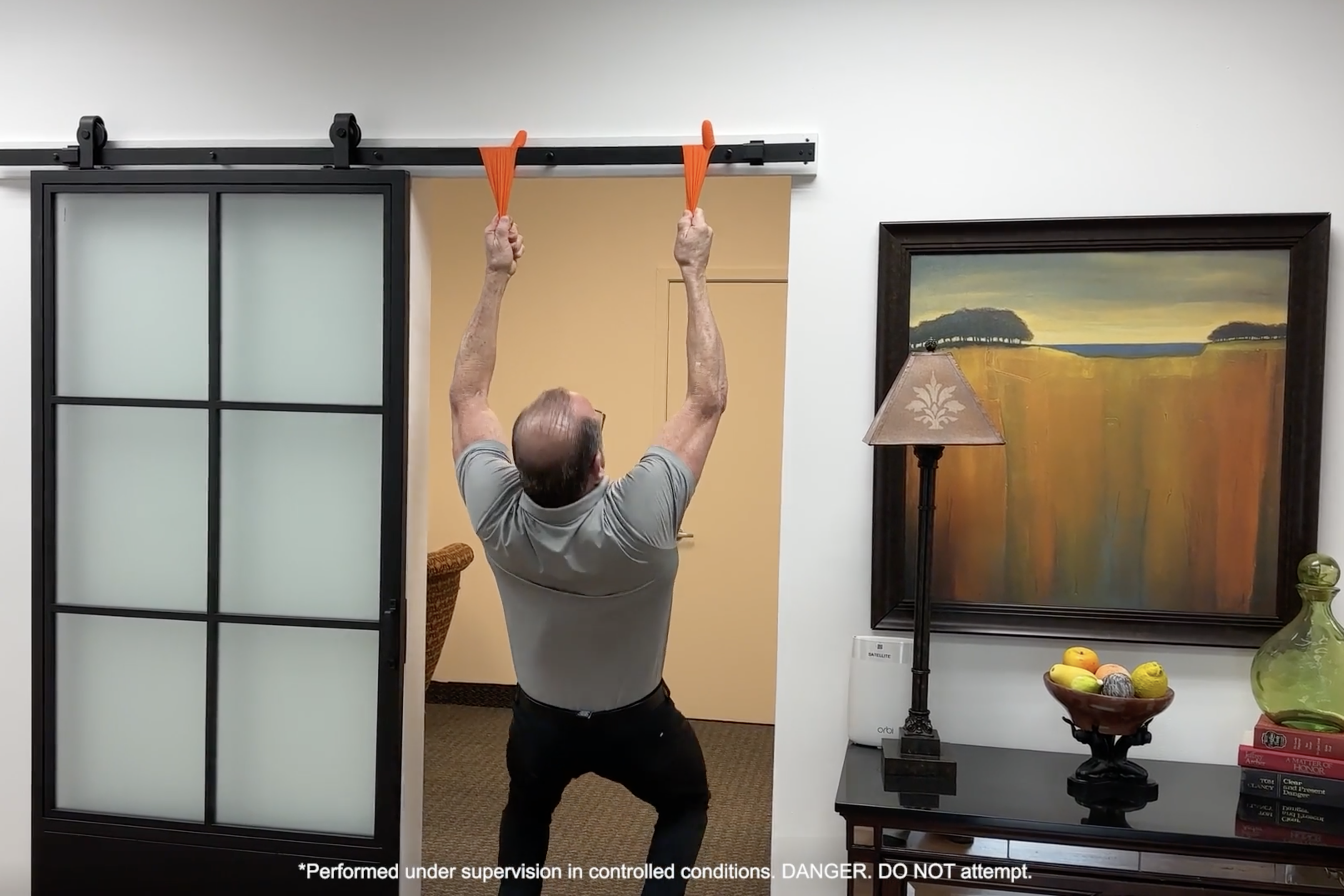 a man attempting to lift himself using the PermaSafe gloves