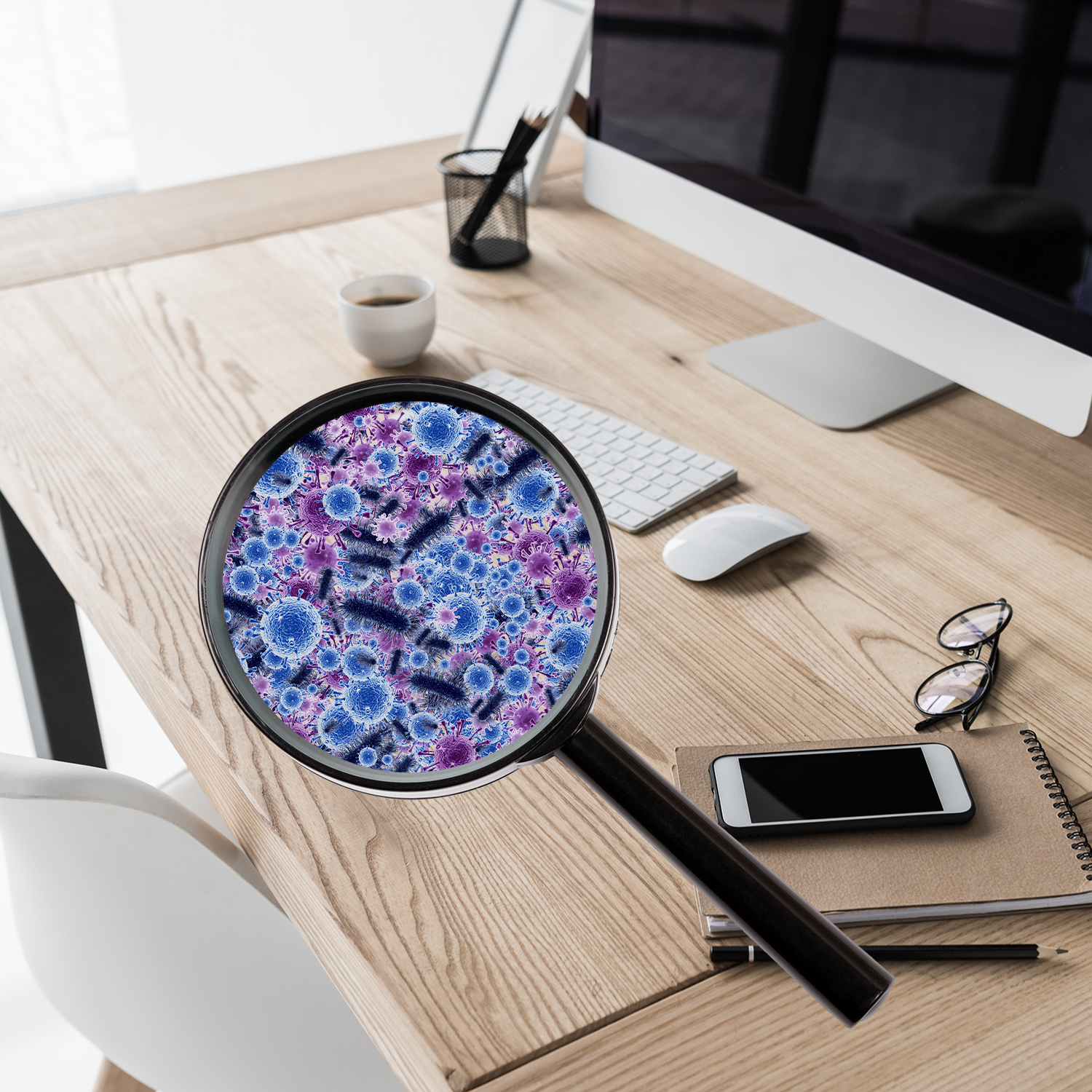 A magnifying glass over a desktop showing 100,000 germs on the surface.