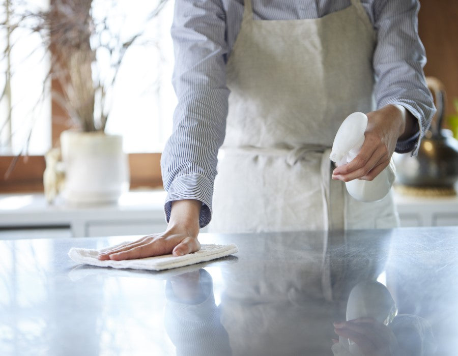 A person using PermaSafe product to clean a surface because PermaSafe is broader spectrum and higher potency than most cleaners.