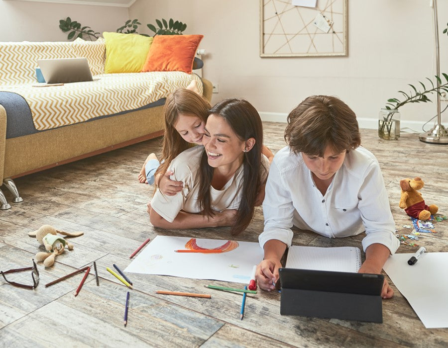 A family playing on the floor, highlighting that permasafe shield offers safe, lasting protection for people, pets, and the environment.