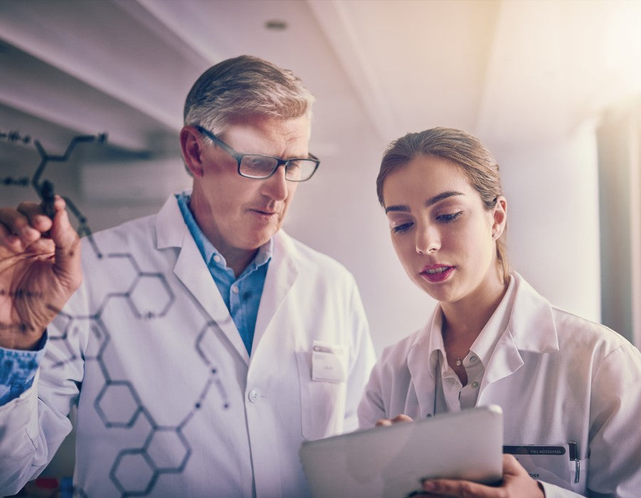 Two people in lab coats studying how PermaSafe products are EPA registered and meet the CDC's standards for the ideal disinfectant which few other products do.