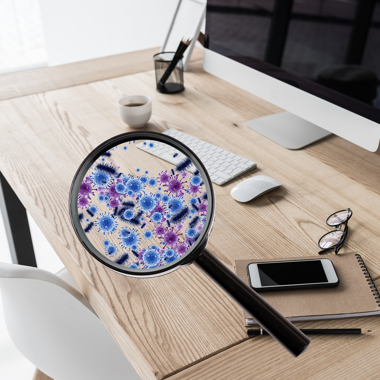 A magnifying glass over a desktop showing 100 germs on the surface.